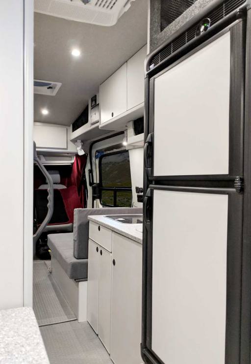 Large upgraded refrigerator in this custom van conversion.