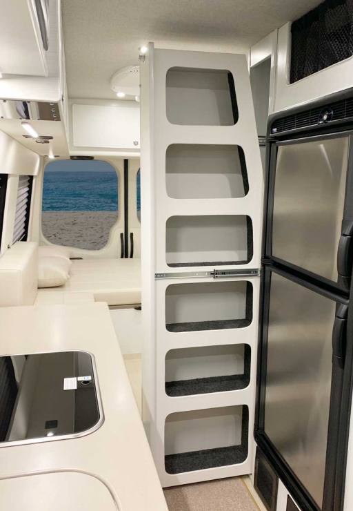 Slide out pantry features extra vertical storage in galley.