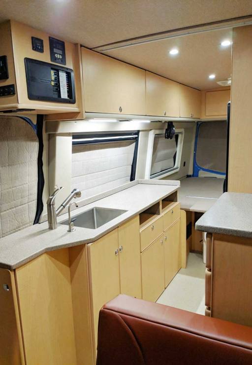 Galley features sink, microwave, and a refrigerator.