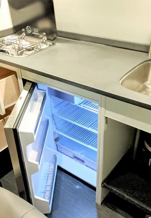 Galley includes a stainless steel refrigerator.