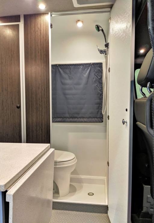 Batch compartment includes shower and toilet.