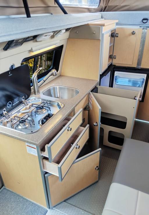 Galley features cooktop, sink, and refrigerator.