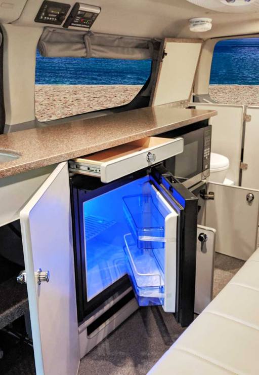Galley featuring a refrigerator and microwave.