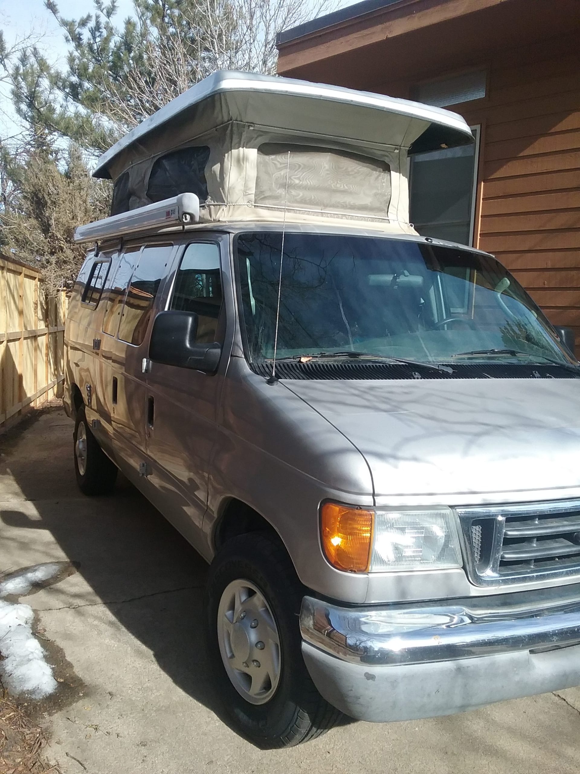 Grey 2003 Ford E350 EB with Penthouse top.