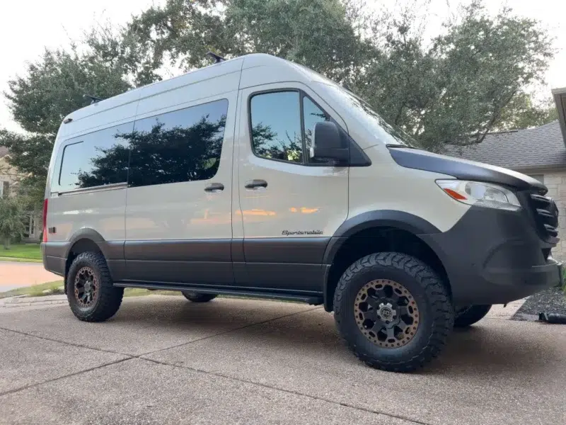 Pebble grey Sprinter camper van parked on a driveway