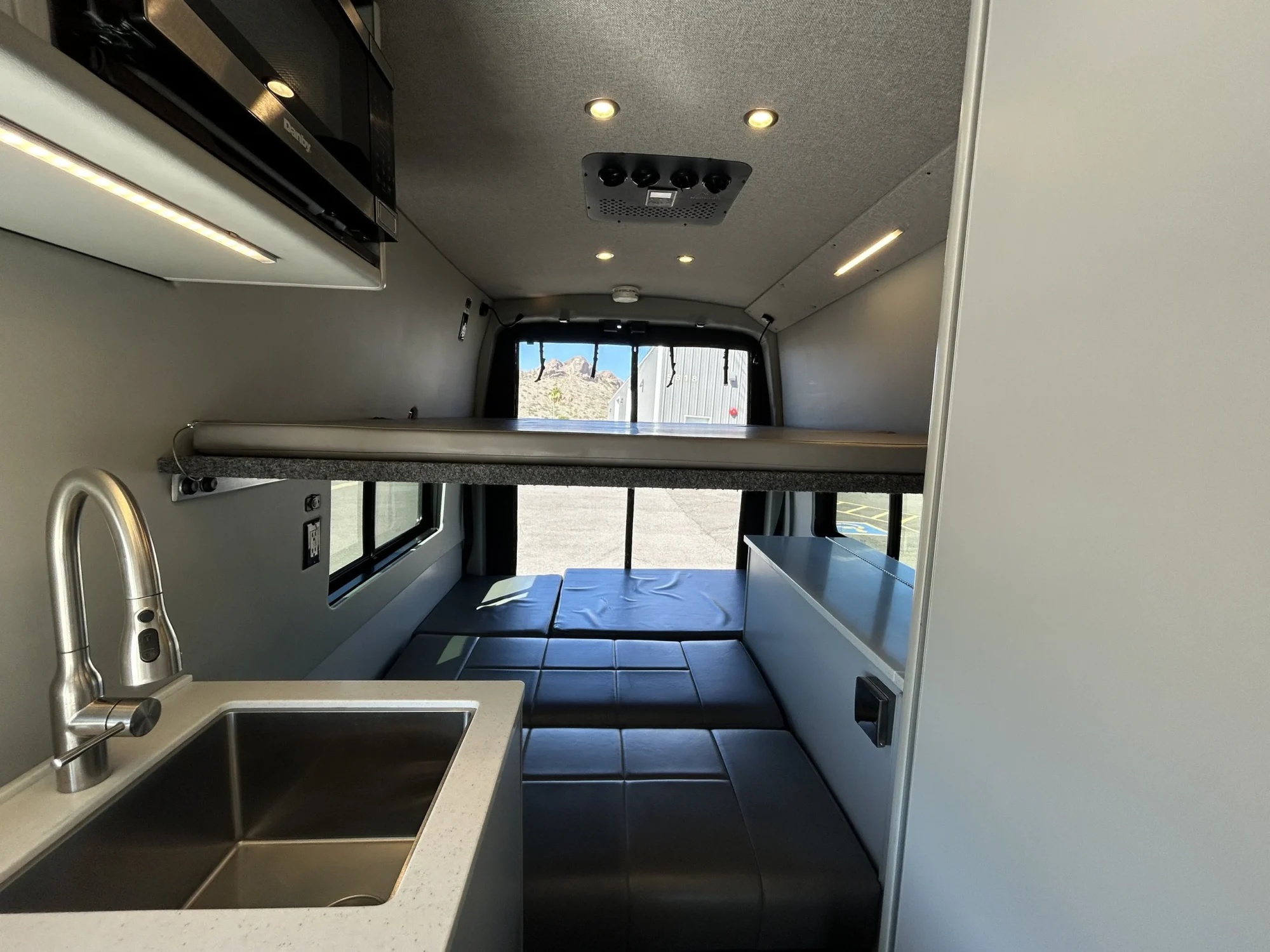 2024 Ford Transit 350 148 High Roof AWD, rear cabin with both upper platform bed and lower mattress set up for sleeping