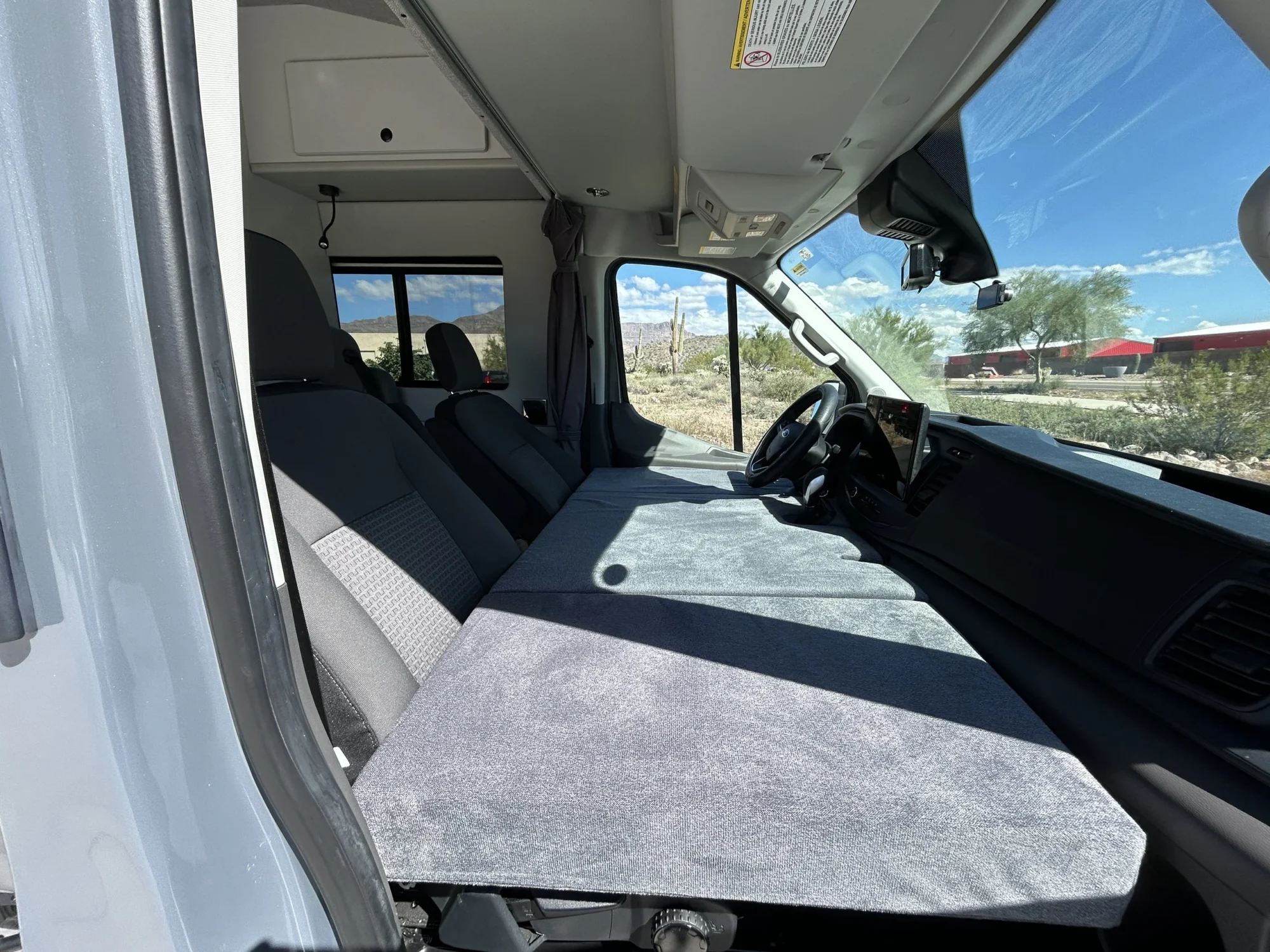 2024 Ford Transit 350 148 High Roof AWD, folding cab bed mattress set up across the driver and passenger seats