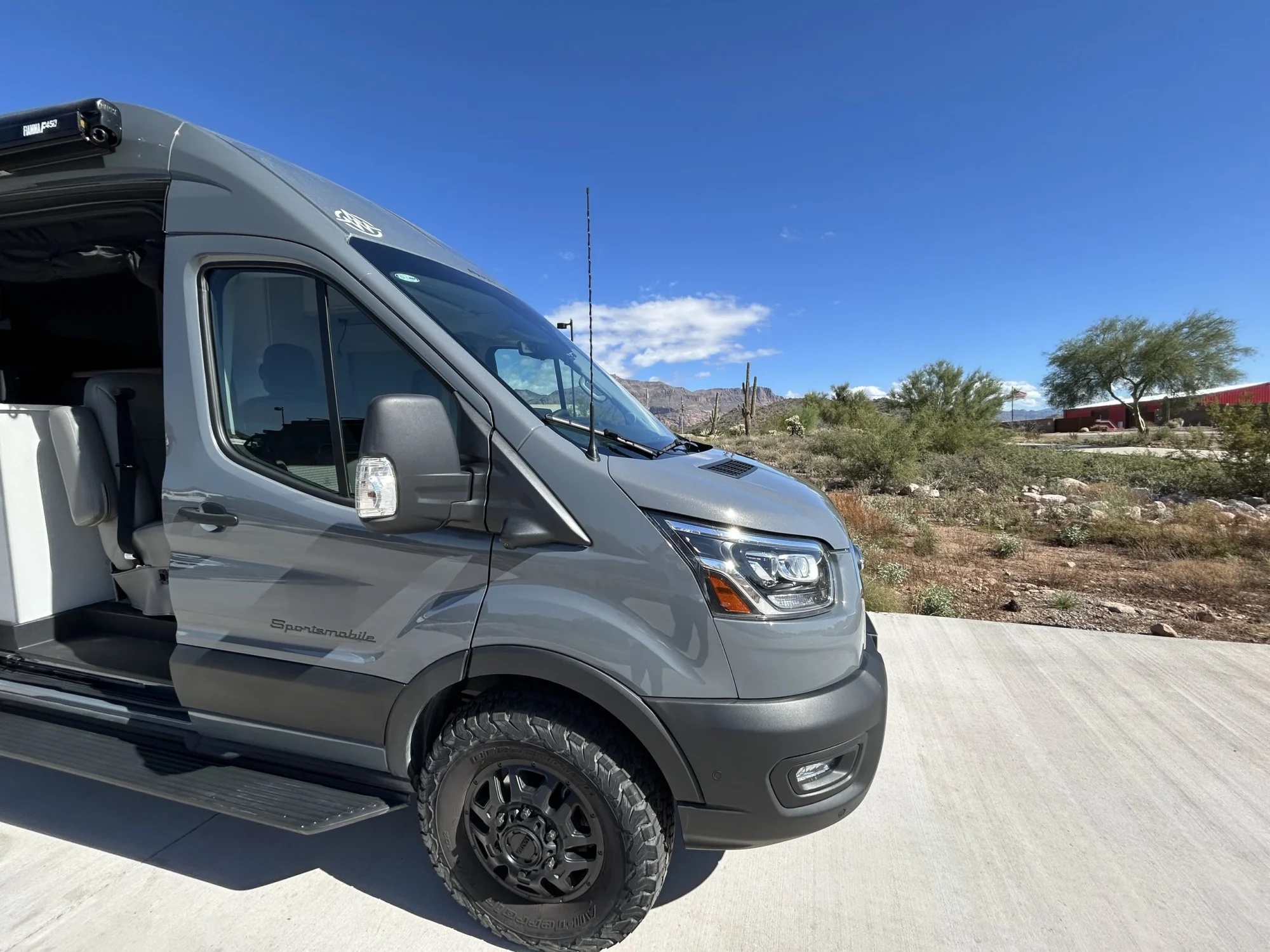 2024 Ford Transit 350 148 High Roof AWD, front passenger-side three-quarter exterior view with sliding door open