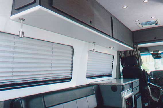 Van conversion with upgraded cabinets and leather gaucho.