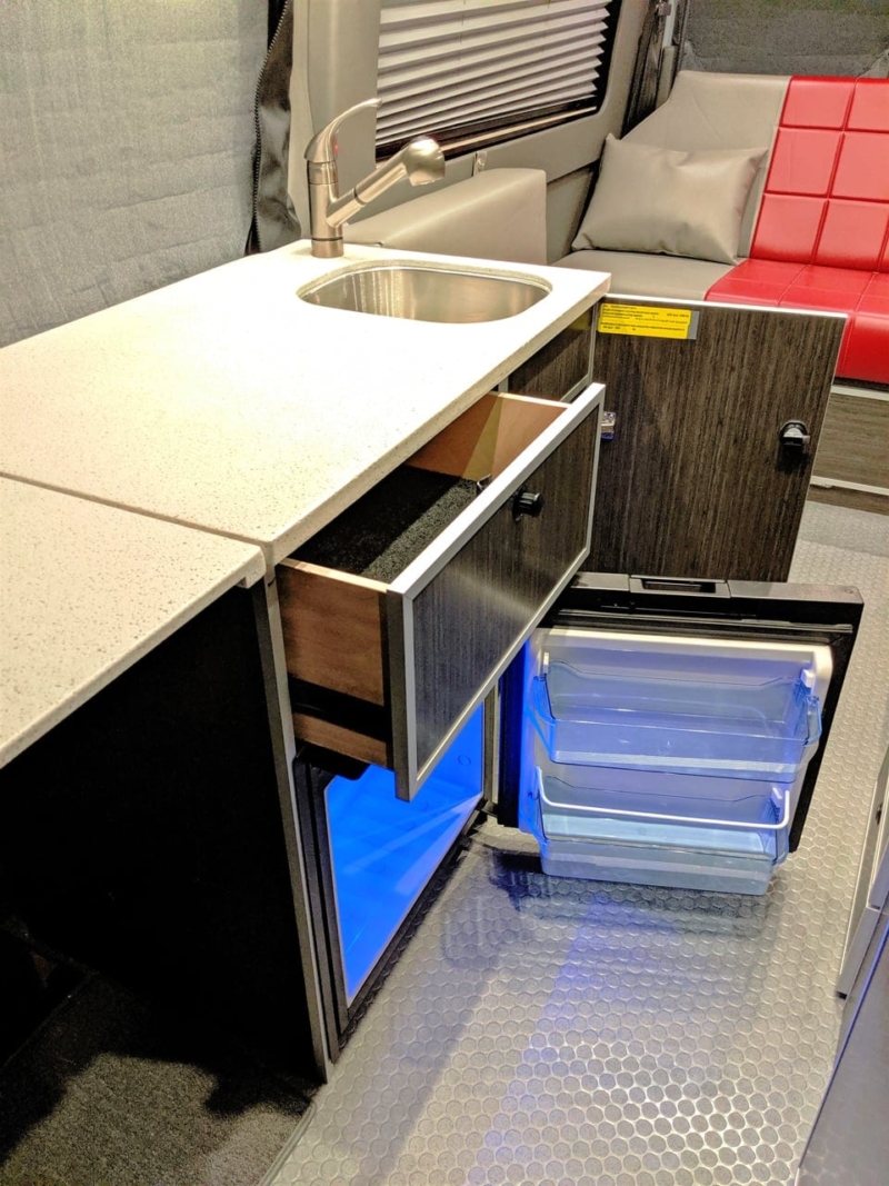 Galley area with sink, refrigerator, and counter space.