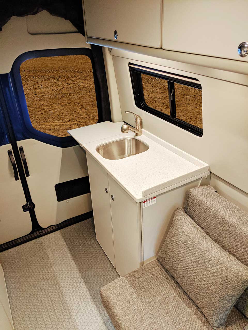 Sink cabinet in rear of van.