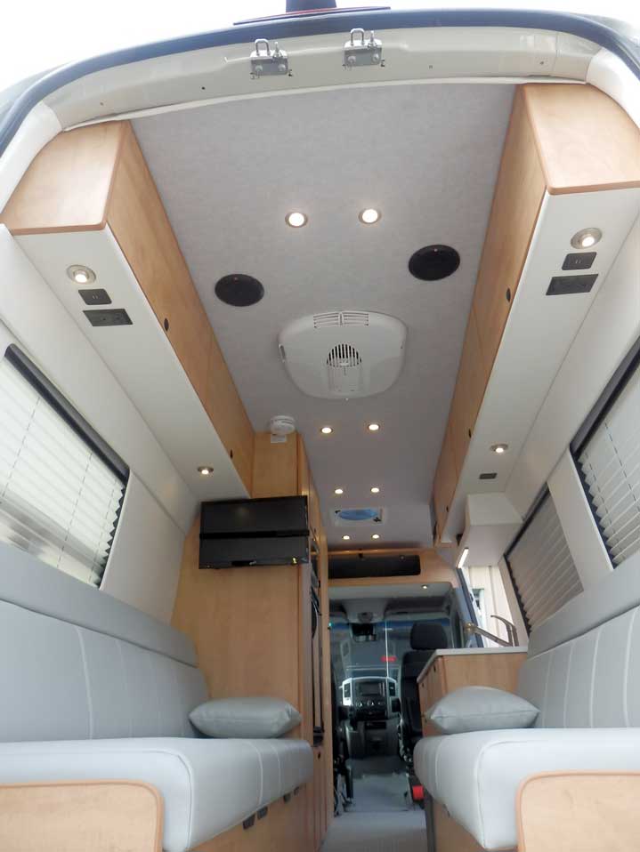 Ford Transit camper conversion with dinette that converts into beds.