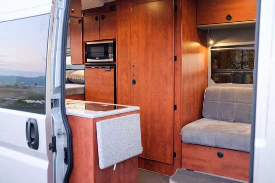 Custom van conversion outfitted with upgraded cherry cabinets.