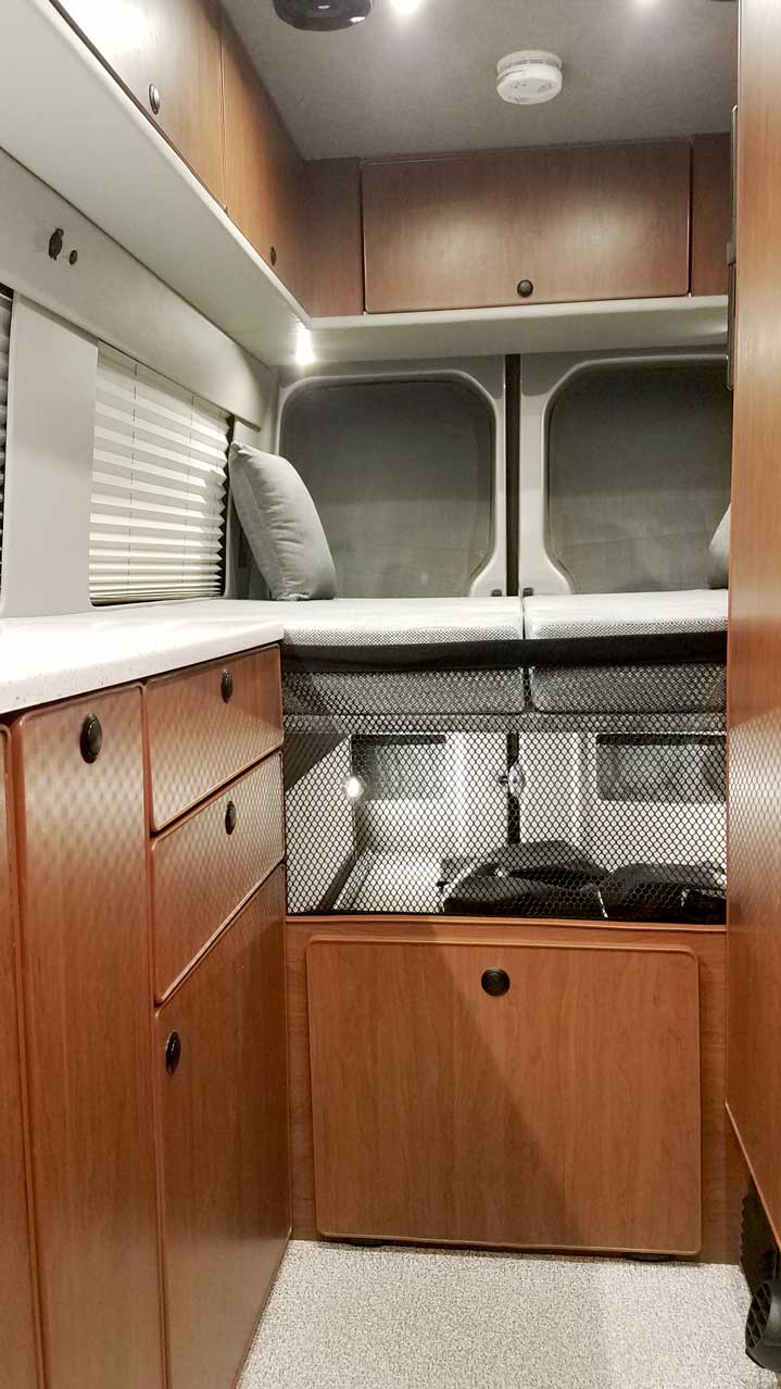 Interior view of a Sportsmobile Sprinter EB custom camper van conversion.