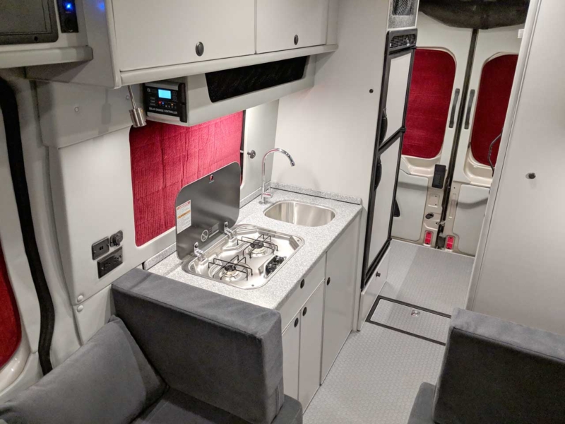 Propane stove, refrigerator, and microwave in the galley.