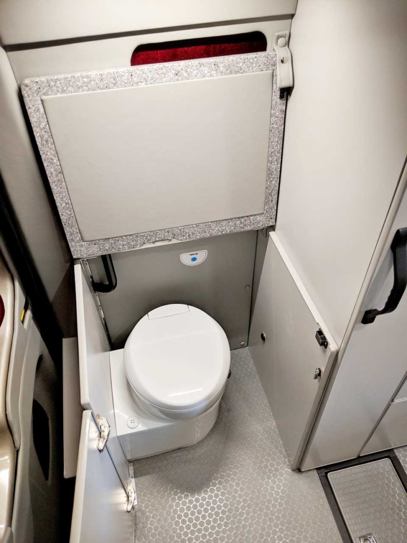 Door and extension open exposing interior toilet.