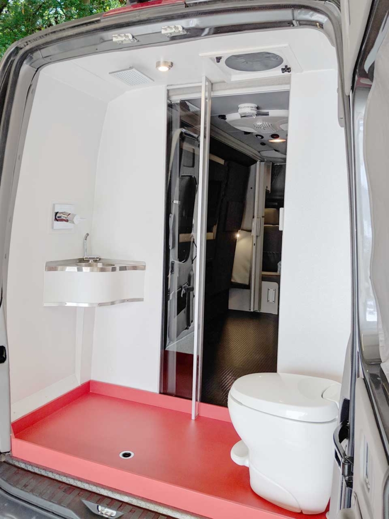 Bath area in the rear of van with shower and toilet.