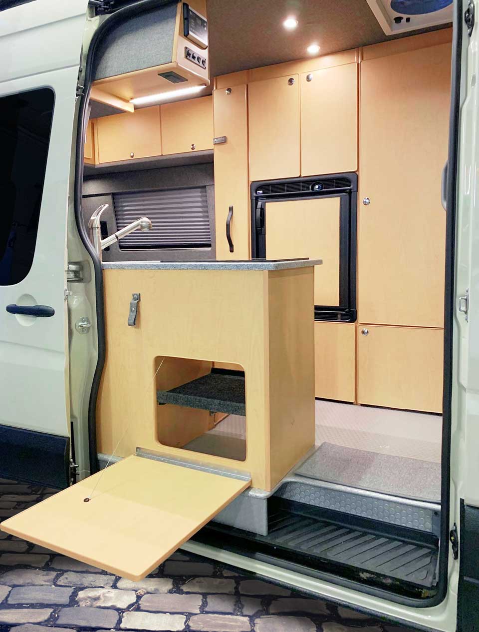 Galley cabinet features a dropdown table for outside use.