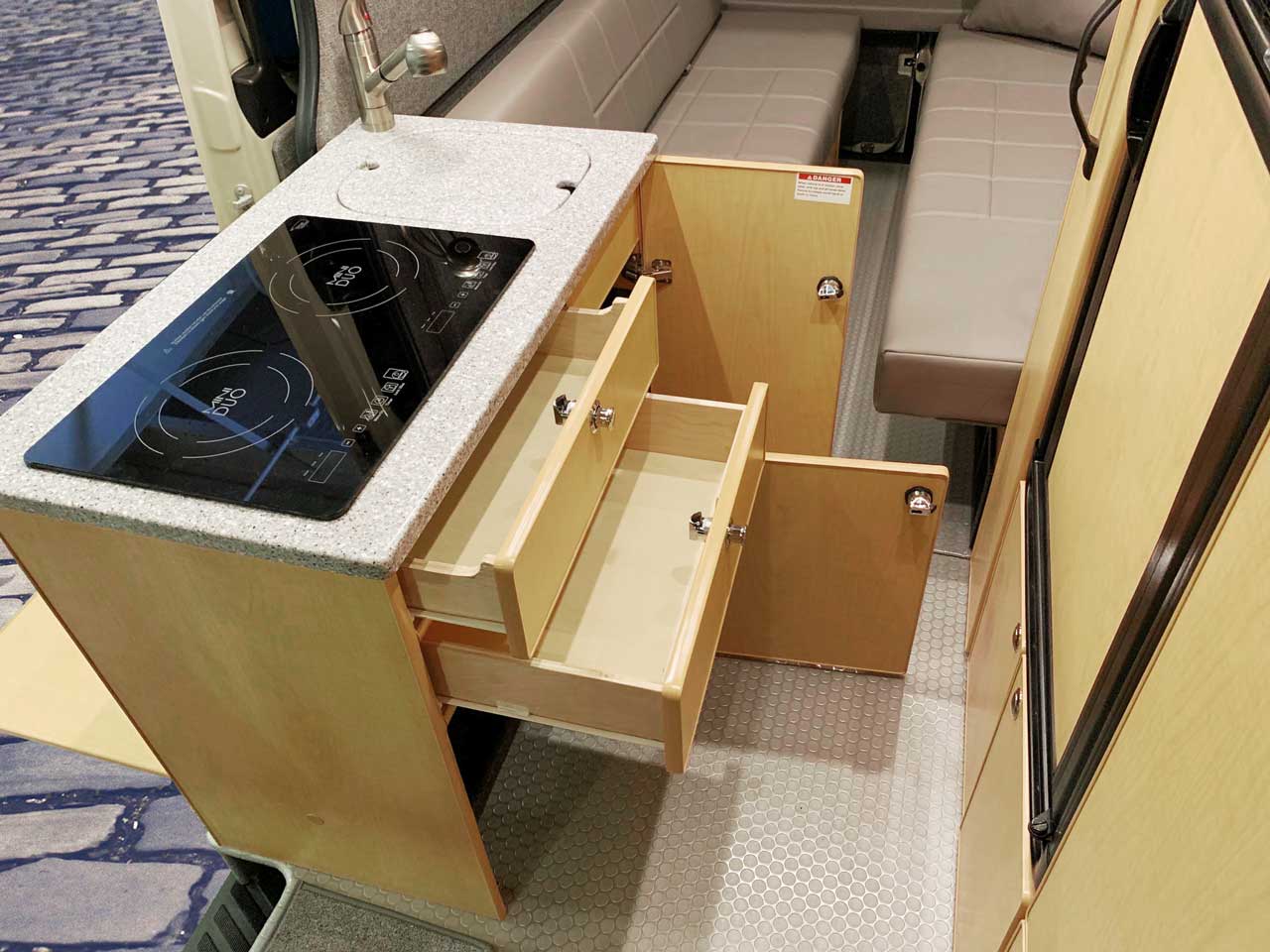 Galley features cooktop and cabinets.