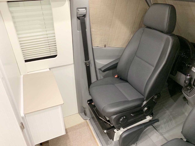 Front driver's seat facing cabinets that can be used as a small office.