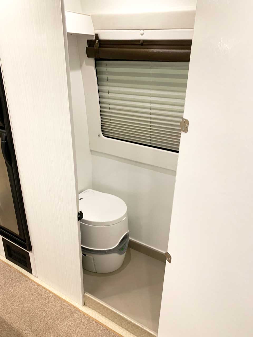 Bath compartment features toilet and shower.