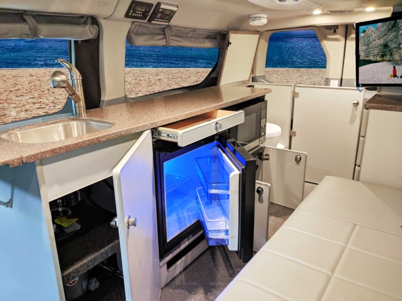 Galley featuring a refrigerator and microwave.