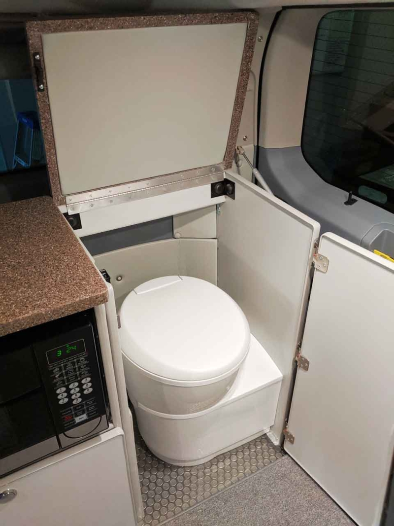 Out of site cassette toilet in rear compartment.