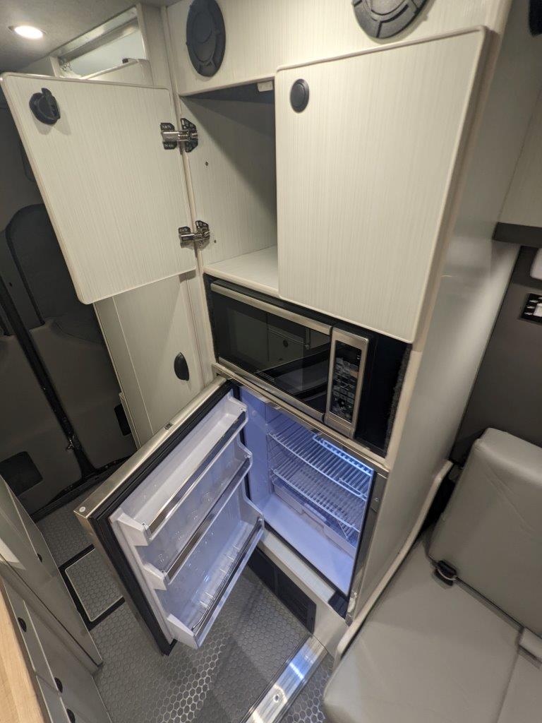Isotherm refrigerator and microwave in Sprinter 144 camper van