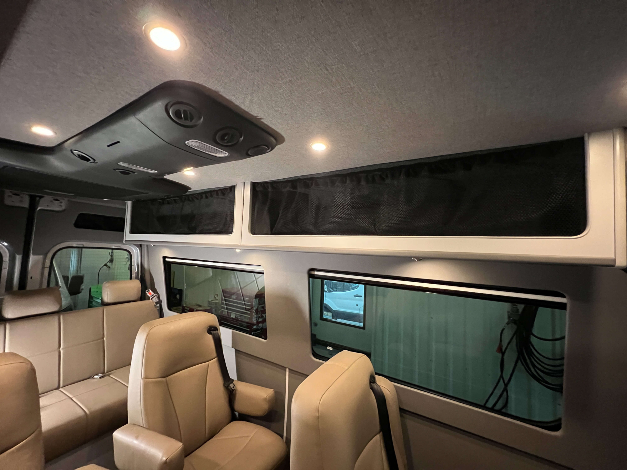 Ample overhead storage compartments in luxury Sprinter 144