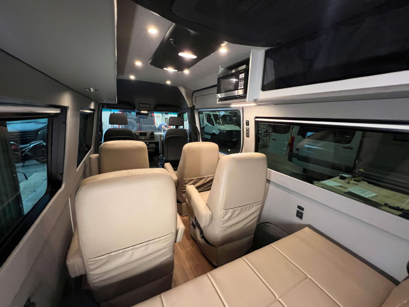 Interior view showing seating for 9 passengers with belted seats