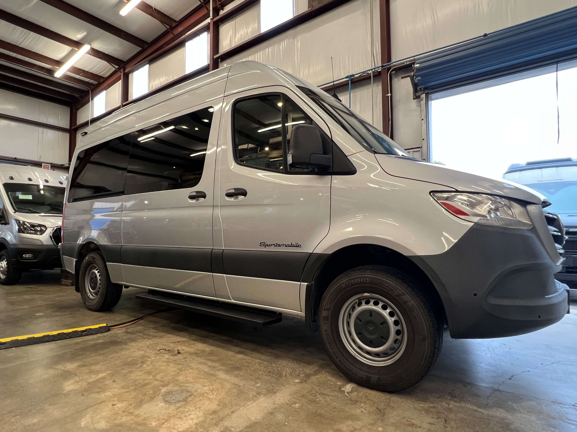 Full exterior side view of Mercedes Sprinter 144 high roof van