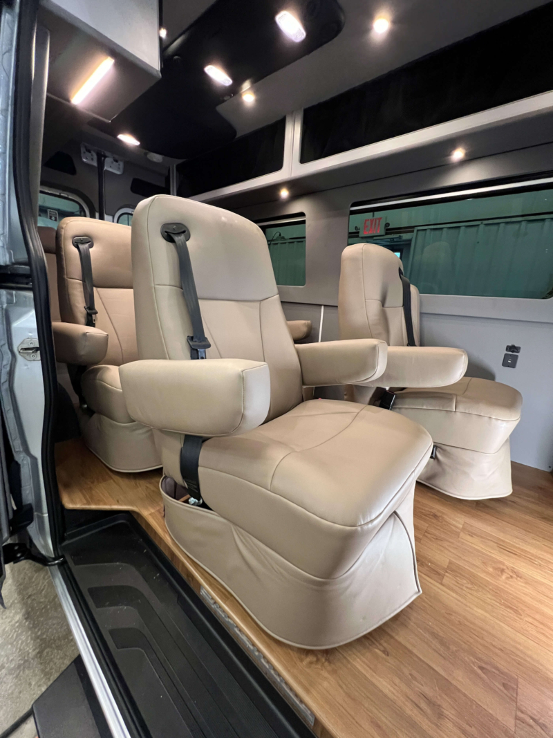 Four captain’s chairs inside Mercedes Sprinter 144 luxury van