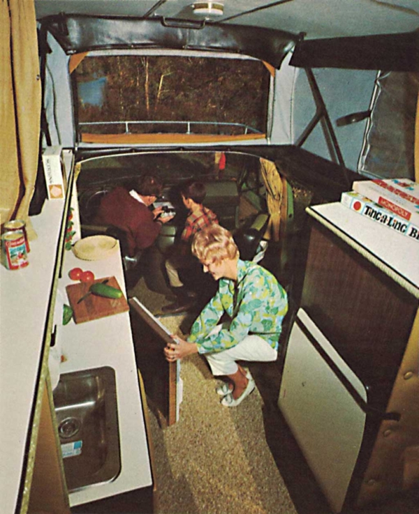 A family of three packing things inside their van.