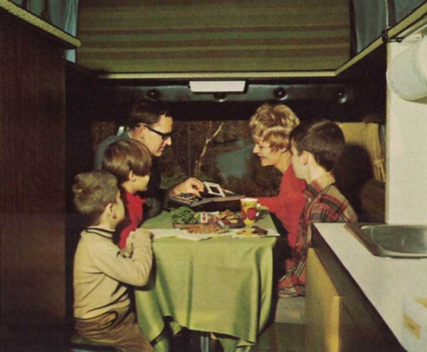 A family of five having a meal in their van.