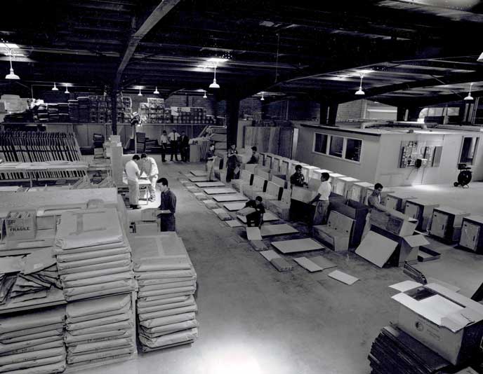 View from inside of Sportsmobile's factory. Employees working on van conversions. Picture from 1961.