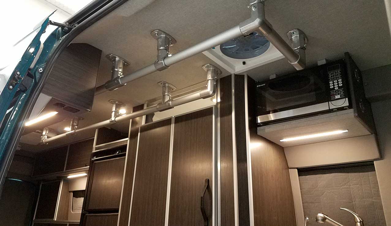 Interior view of a Sportsmobile Sprinter with support rails.