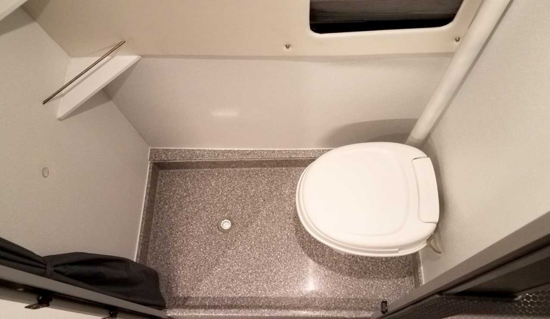 Interior view of a Sportsmobile Sprinter with accessible toilet.