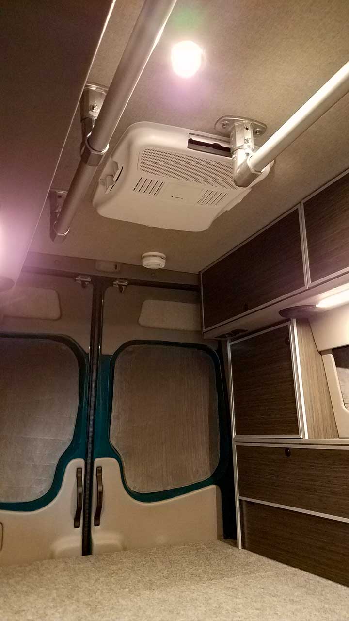 Interior view of a Sportsmobile Sprinter with accessibility rails.