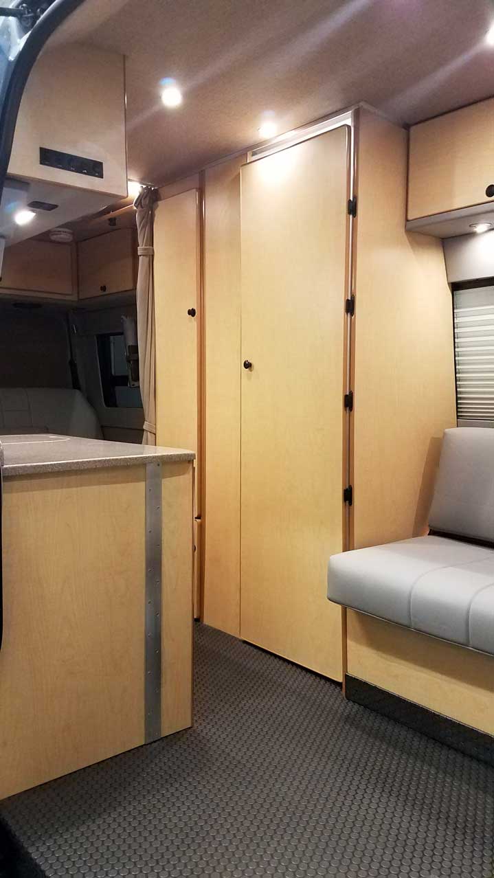 A bath compartment and closet are located in mid-section.